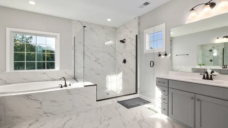 Spotless marble bathroom with a glass shower and clean vanity