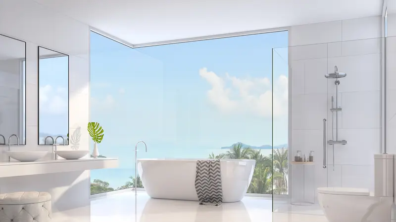 Bright white bathroom with a freestanding tub and a wide window
